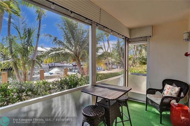 a view of a chairs and table in patio with a yard