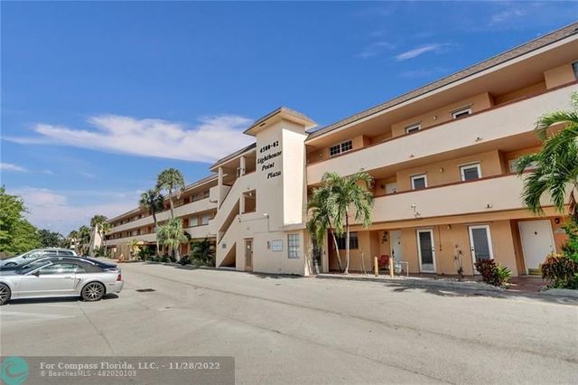 a view of a white apartments with large windows