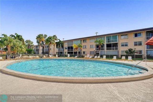 a view of a house with a backyard porch and sitting area