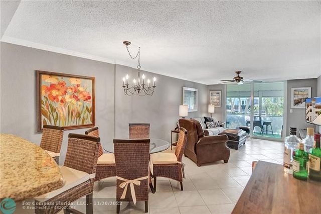 a living room with furniture chandelier and a flat screen tv