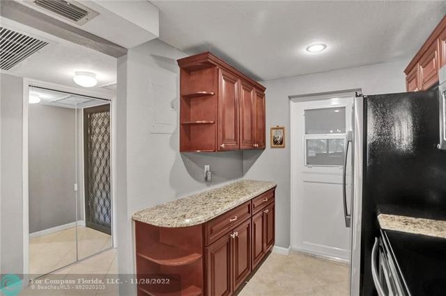 a kitchen with stainless steel appliances granite countertop a refrigerator and a stove