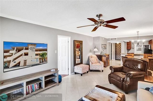 a living room with furniture and a ceiling fan