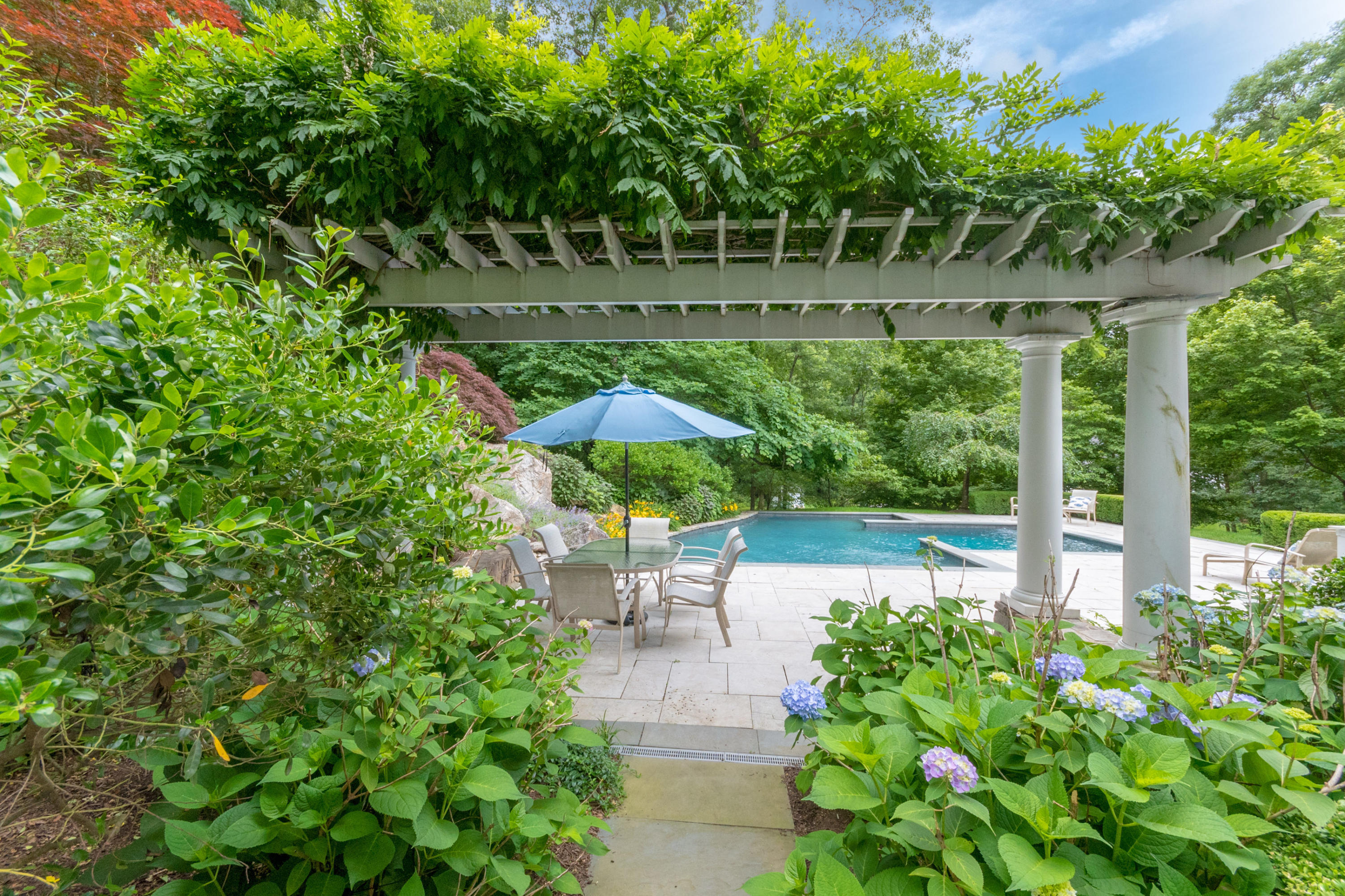 16 Circle Road Darien, CT 06820 - Photo 7 of 49 a view of a chair and table in the garden