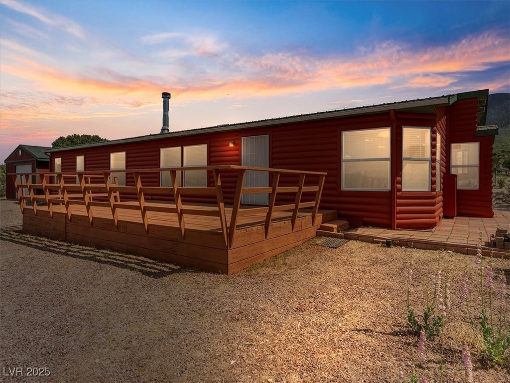 70 West Bonanza Road Las Vegas, NV 89124 - Photo 5 of 71 View of front of home with a deck, metal roof, and faux log siding