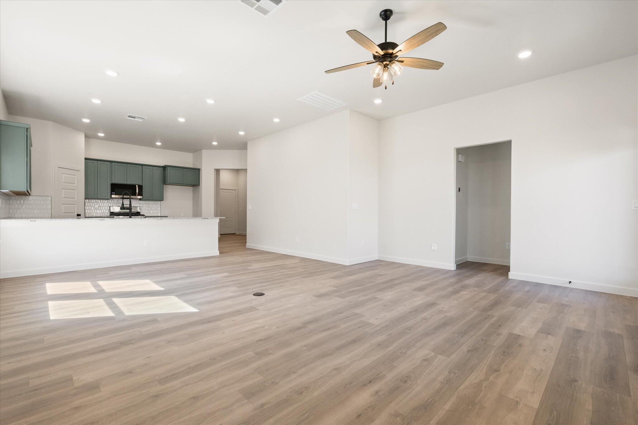 7003 53rd Street Lubbock, TX 79407 - Photo 7 of 25 a view of a kitchen with a sink and a refrigerator