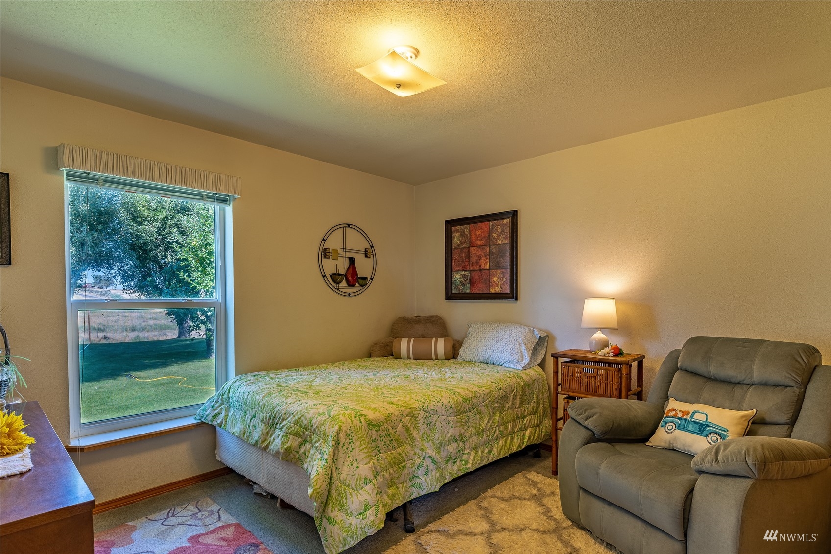 811 South Steele Road Othello, WA 99344 - Photo 25 of 40 a bedroom with a bed and wooden floor