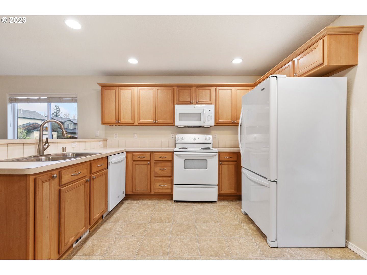 16519 Northeast 12th Avenue Ridgefield, WA 98642 - Photo 13 of 44 a kitchen with white cabinets and white appliances