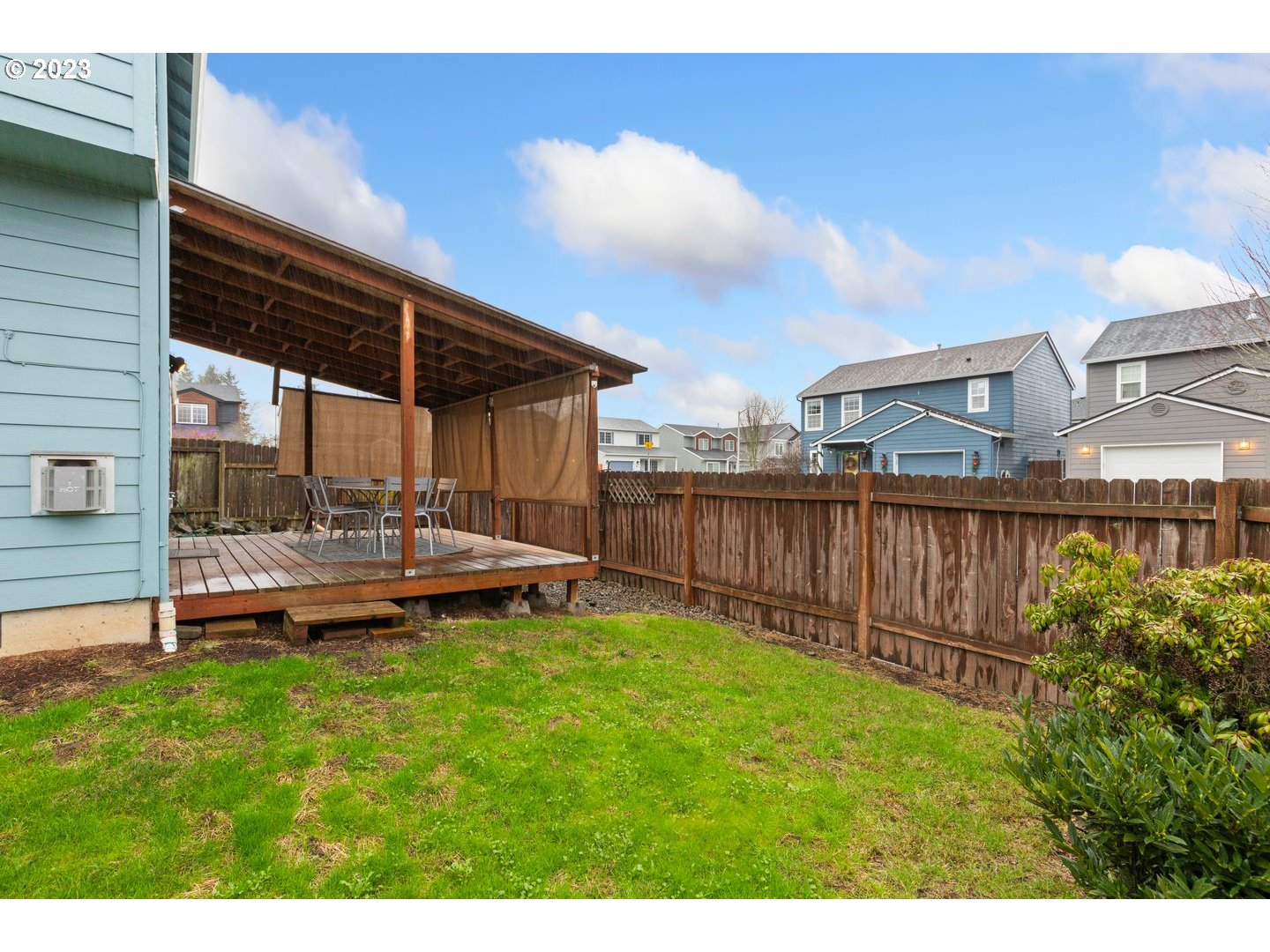 16519 Northeast 12th Avenue Ridgefield, WA 98642 - Photo 41 of 44 a view of a deck with a table and chair under an umbrella
