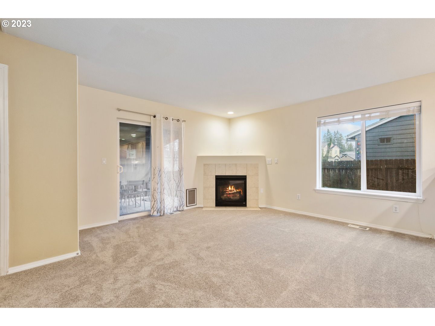 16519 Northeast 12th Avenue Ridgefield, WA 98642 - Photo 7 of 44 a view of an empty room with a fireplace and a window