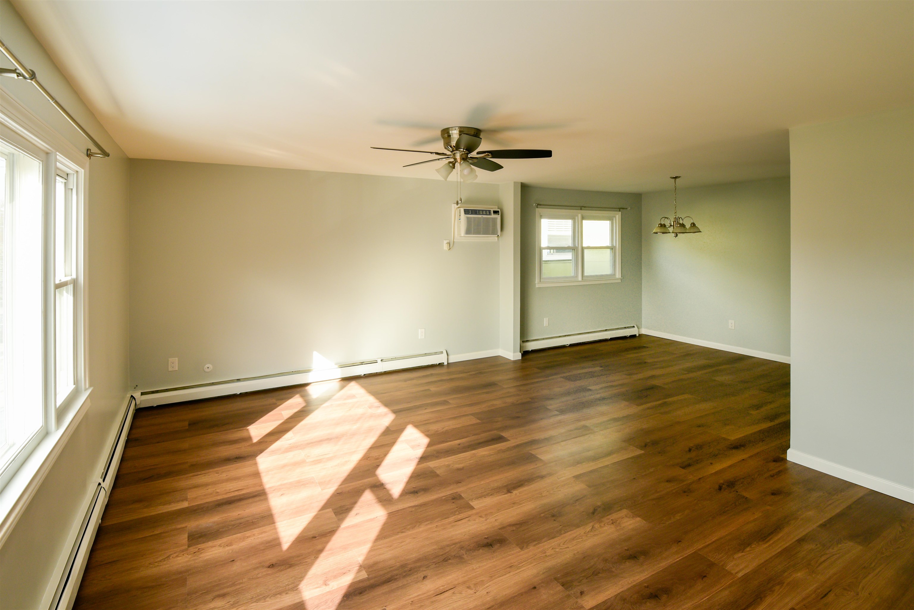 45 East 51st Street Bayonne, NJ 07002 - Photo 11 of 26 an empty room with wooden floor and windows