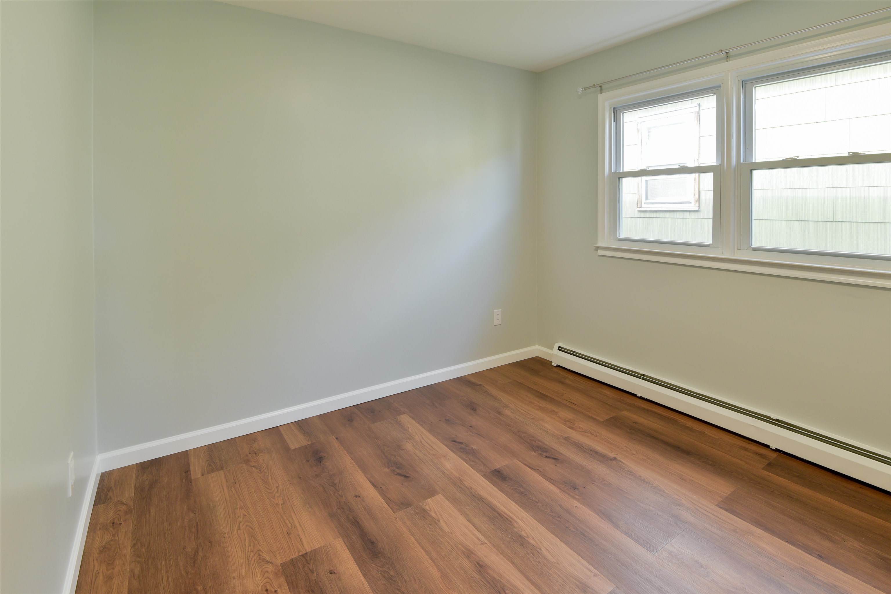 45 East 51st Street Bayonne, NJ 07002 - Photo 16 of 26 a view of an empty room with wooden floor and a window