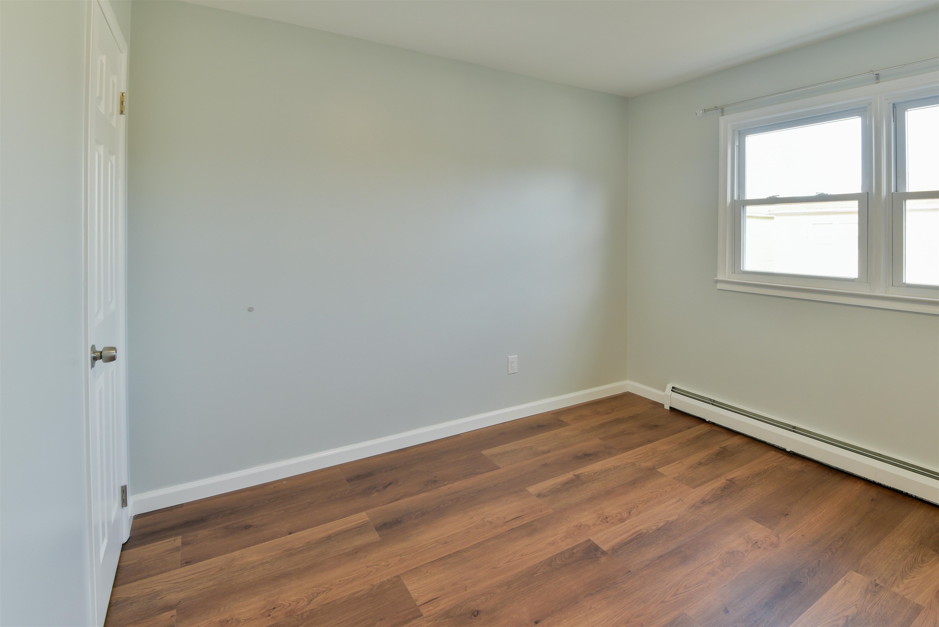 45 East 51st Street Bayonne, NJ 07002 - Photo 17 of 26 an empty room with wooden floor and windows