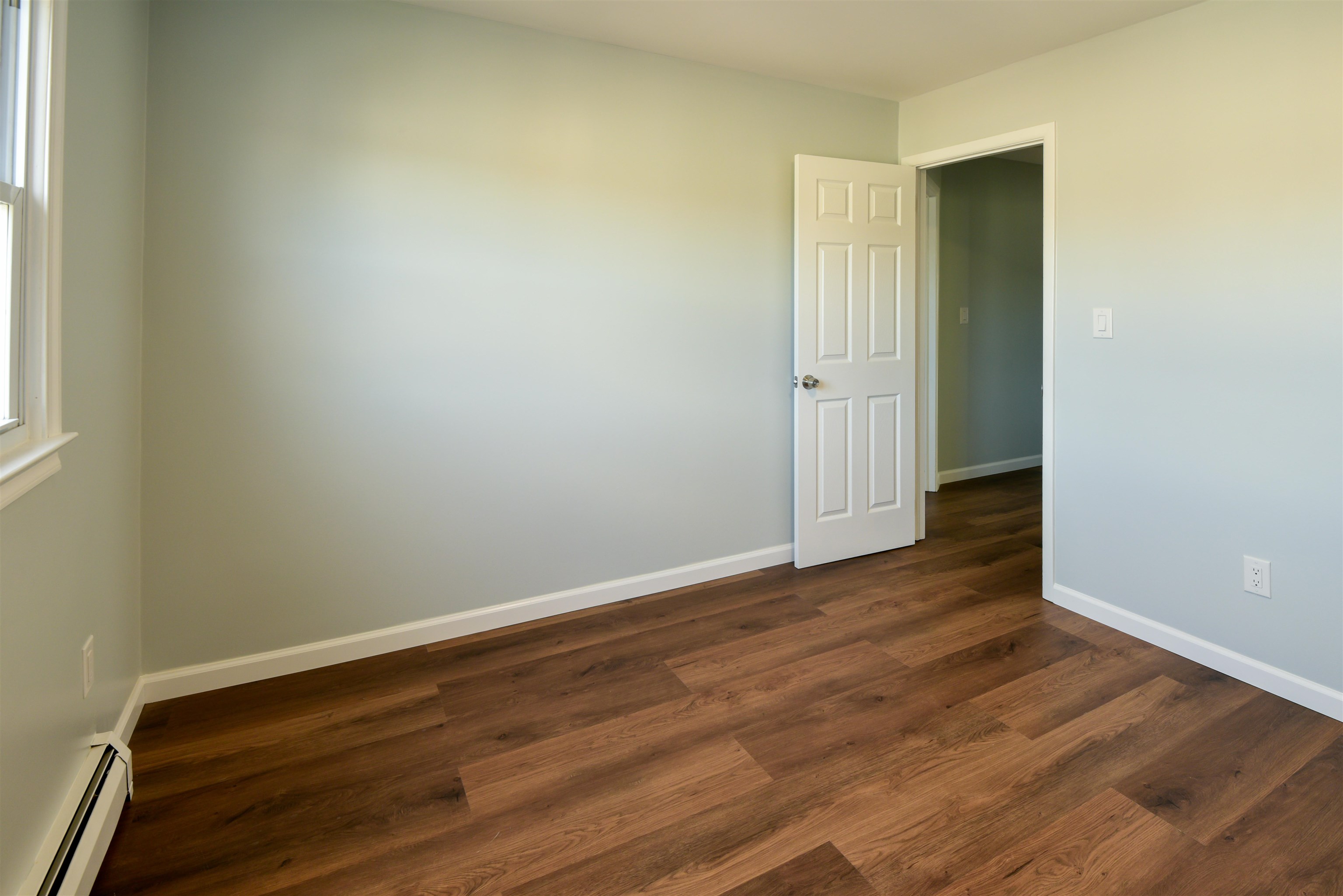 45 East 51st Street Bayonne, NJ 07002 - Photo 19 of 26 an empty room with wooden floor and windows