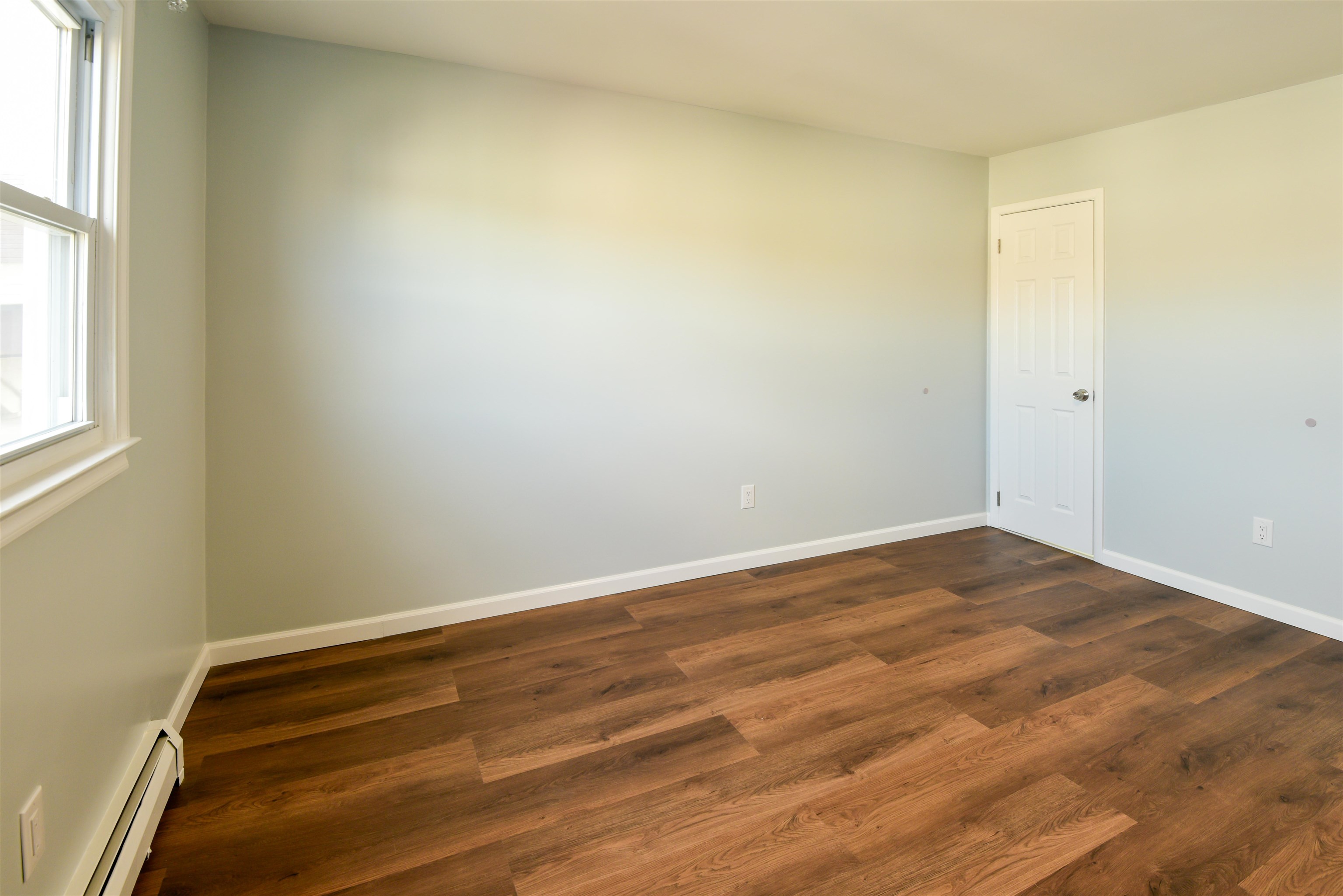 45 East 51st Street Bayonne, NJ 07002 - Photo 20 of 26 an empty room with wooden floor and windows