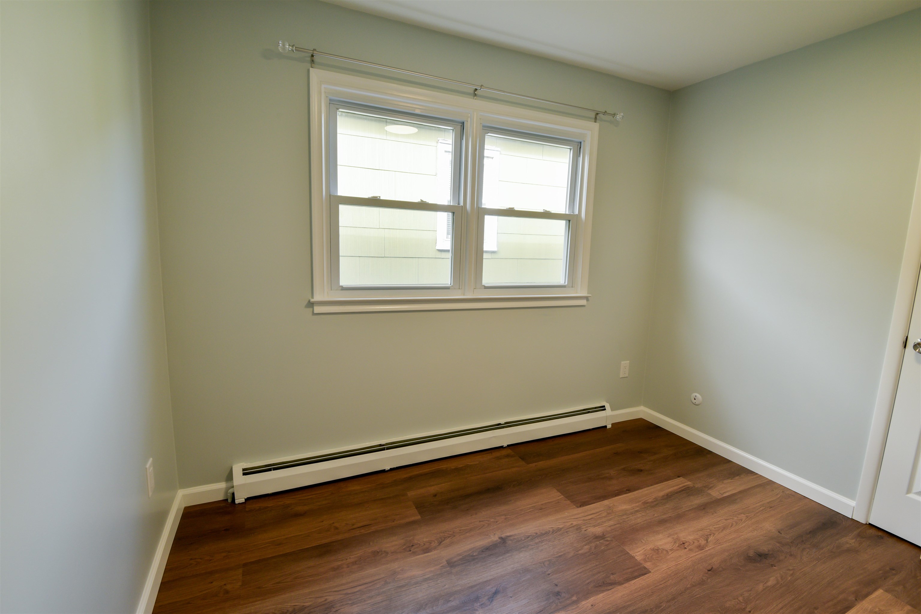 45 East 51st Street Bayonne, NJ 07002 - Photo 24 of 26 an empty room with wooden floor and windows