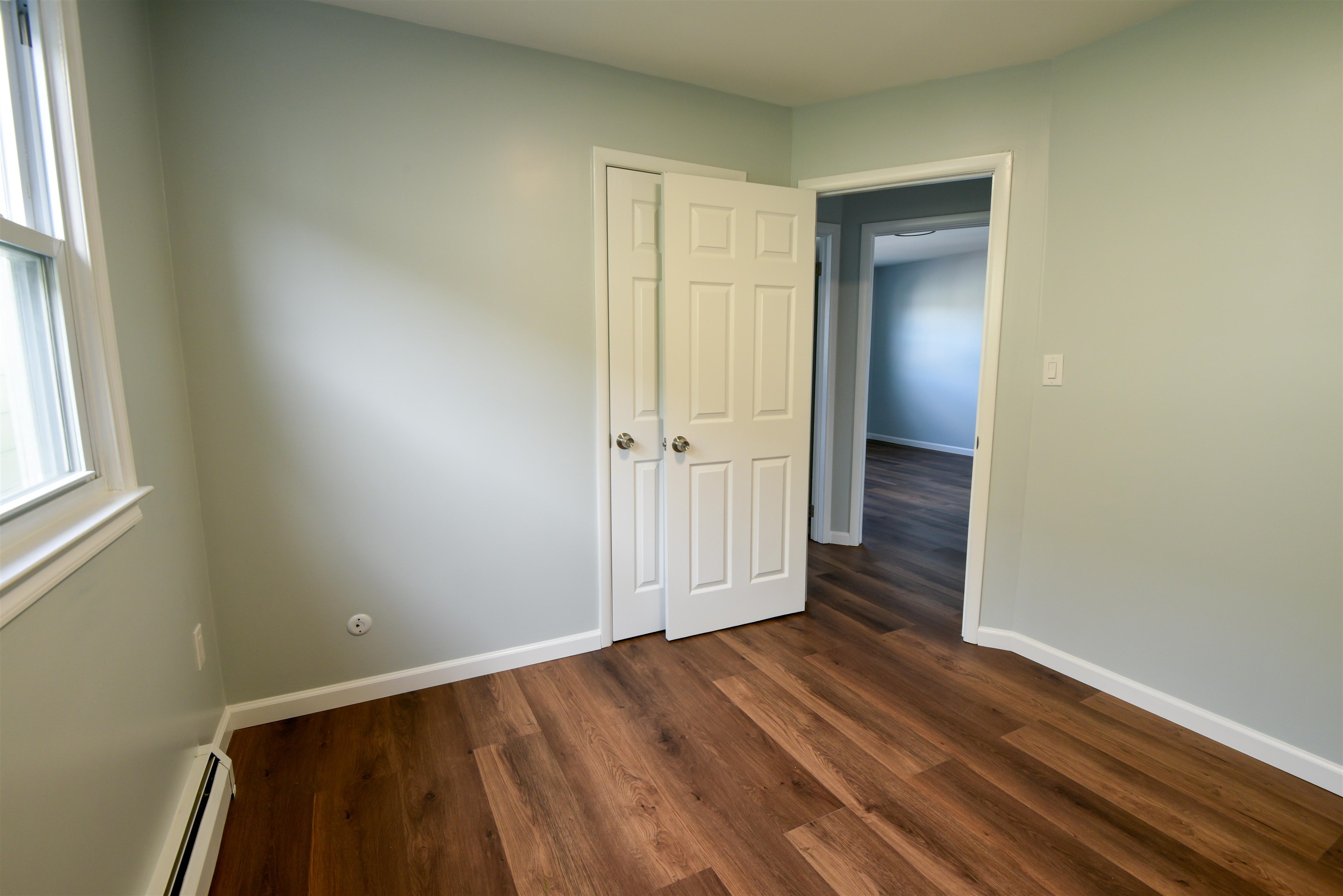 45 East 51st Street Bayonne, NJ 07002 - Photo 25 of 26 an empty room with wooden floor and windows