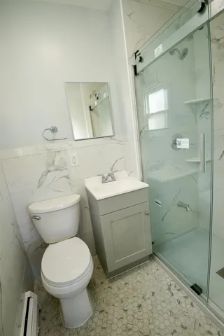 a bathroom with a sink toilet and shower