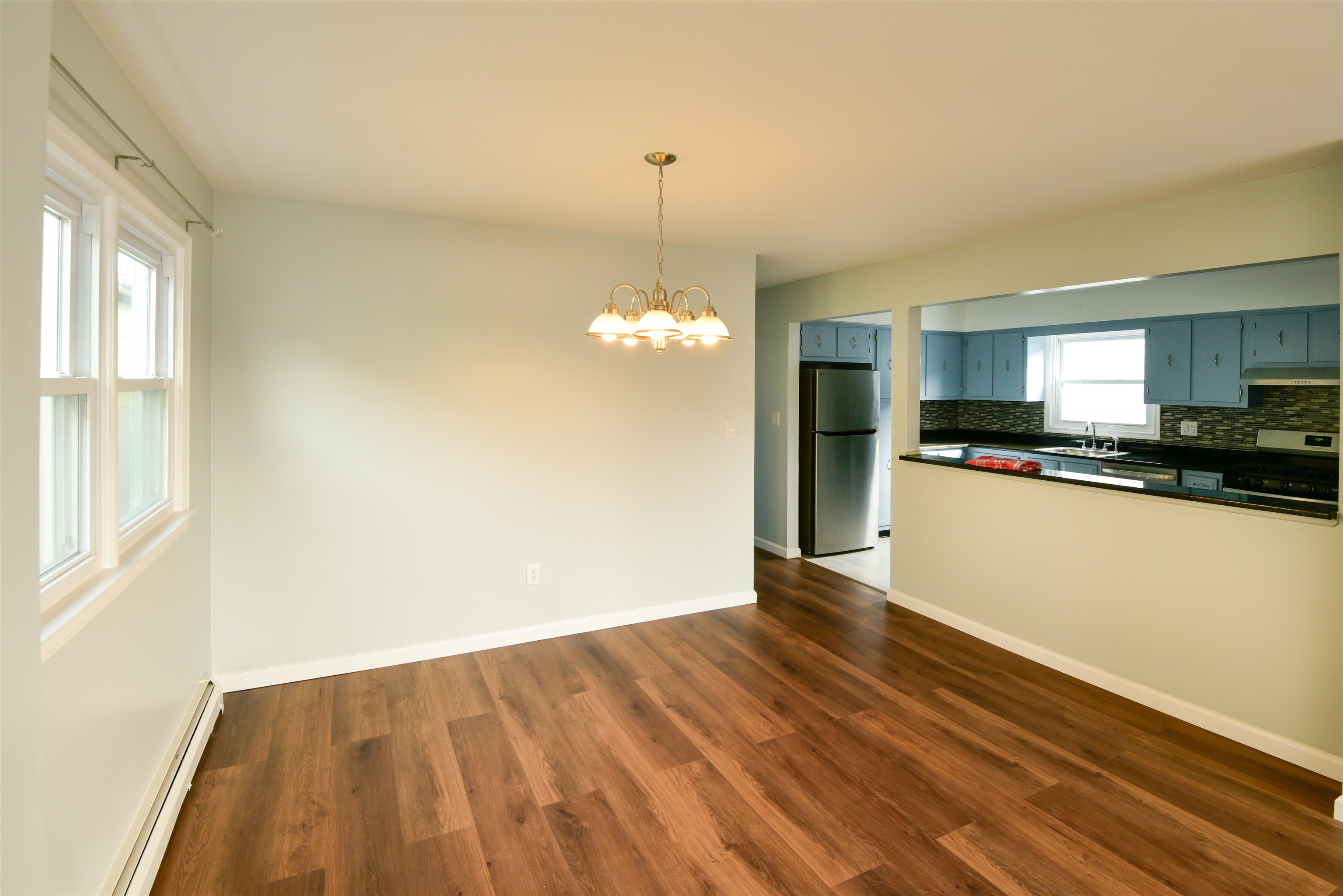 45 East 51st Street Bayonne, NJ 07002 - Photo 3 of 26 a view of a kitchen with wooden floor and an empty space