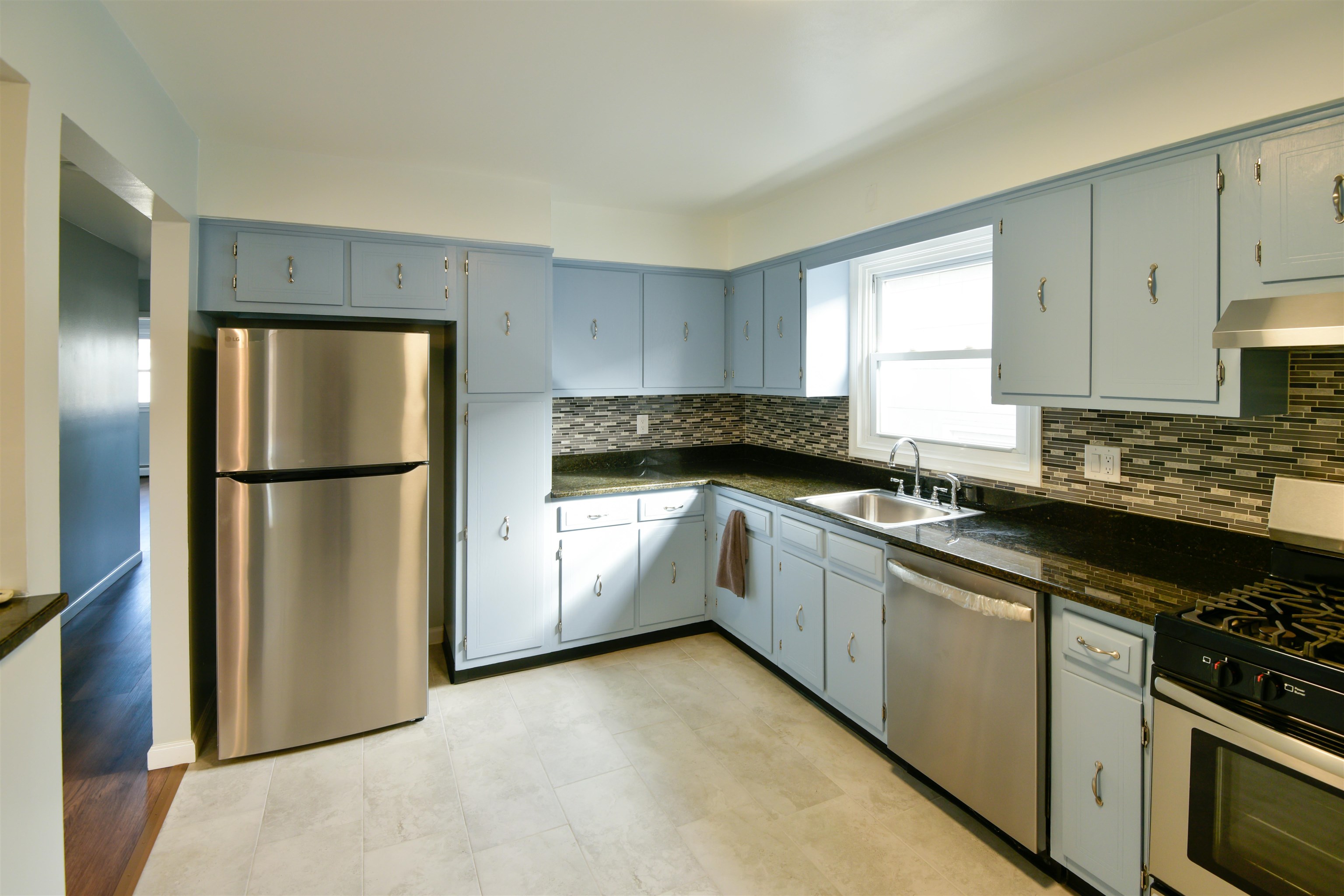 45 East 51st Street Bayonne, NJ 07002 - Photo 4 of 26 a kitchen with granite countertop a refrigerator stove and sink