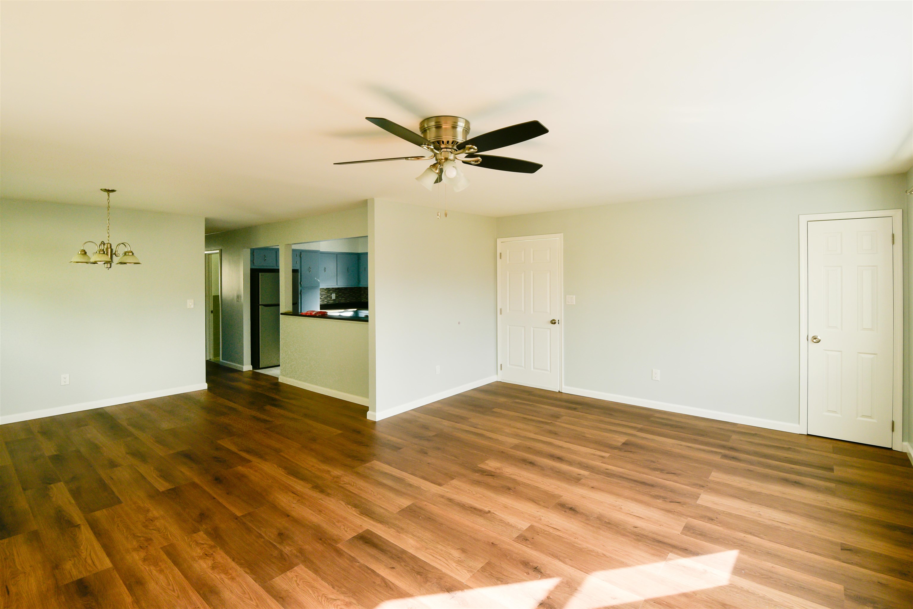 45 East 51st Street Bayonne, NJ 07002 - Photo 8 of 26 a view of a kitchen with wooden floor and a ceiling fan