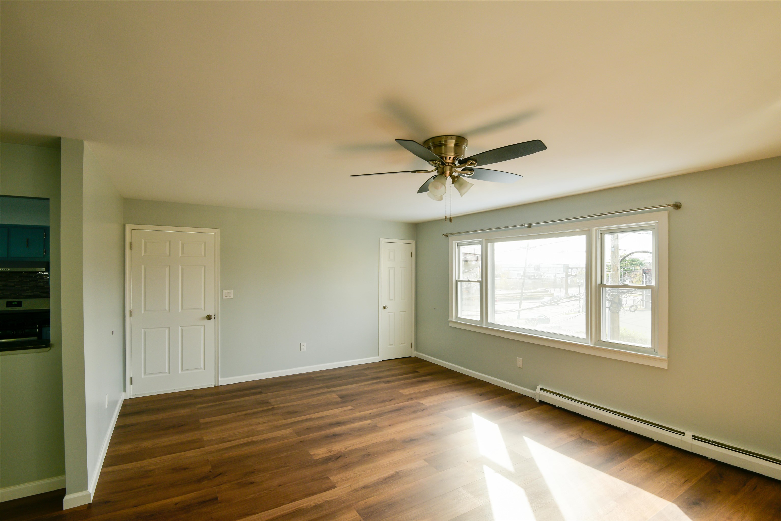 45 East 51st Street Bayonne, NJ 07002 - Photo 10 of 26 a view of a livingroom with a ceiling fan and window