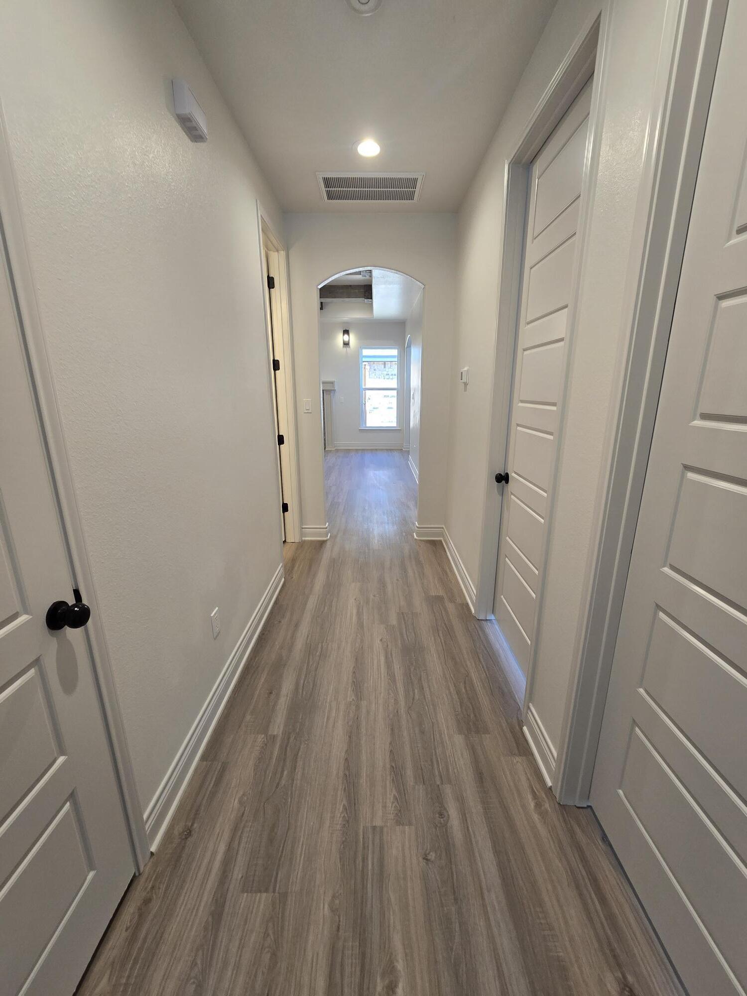 7814 53rd Street Lubbock, TX 79407 - Photo 13 of 24 a view of a hallway with wooden floor and staircase