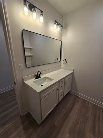 a utility room with a sink and mirror