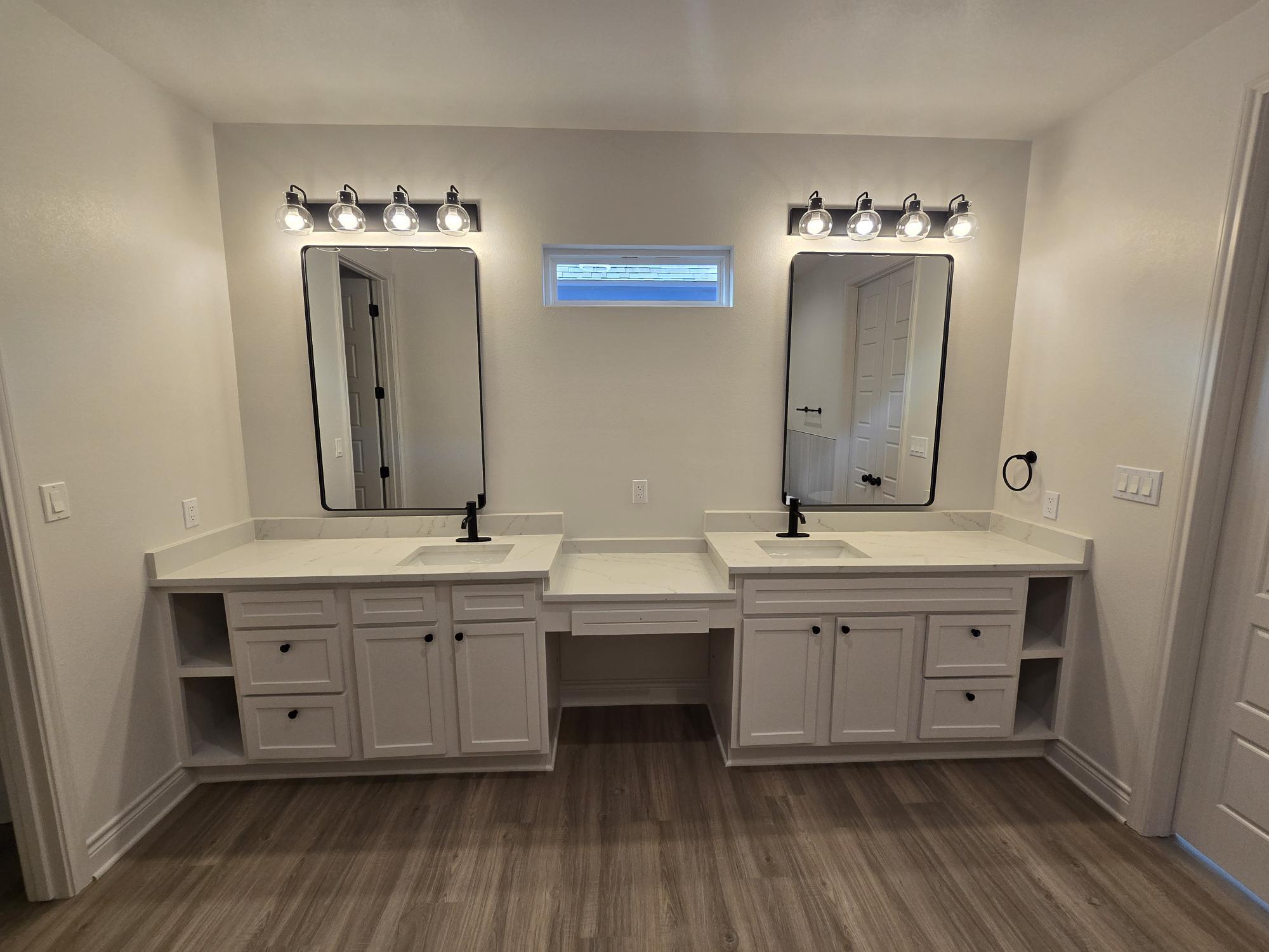 7814 53rd Street Lubbock, TX 79407 - Photo 20 of 24 a bathroom with a double vanity sink and a mirror