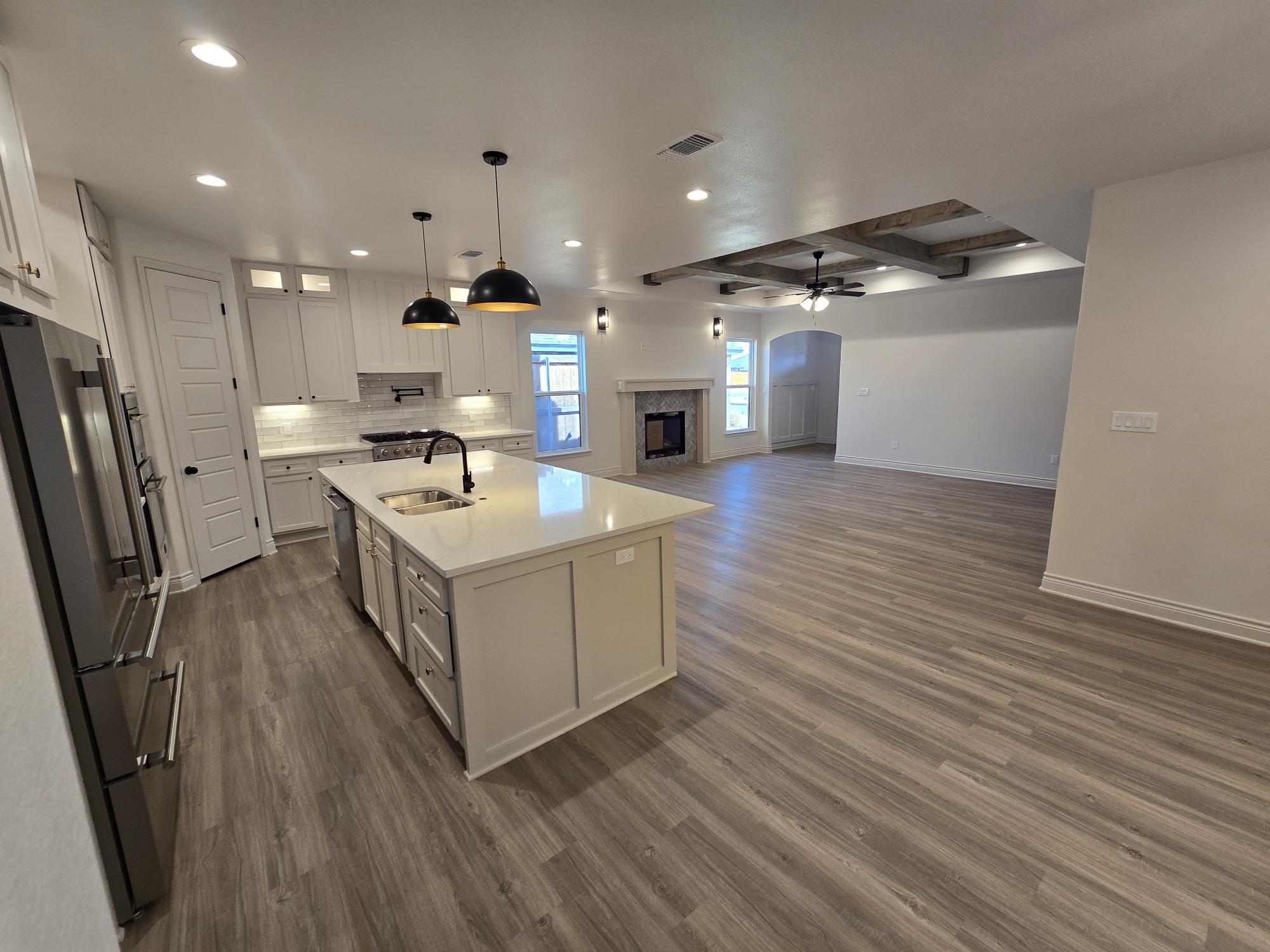 7814 53rd Street Lubbock, TX 79407 - Photo 4 of 24 a kitchen with a sink cabinets stainless steel appliances and a window