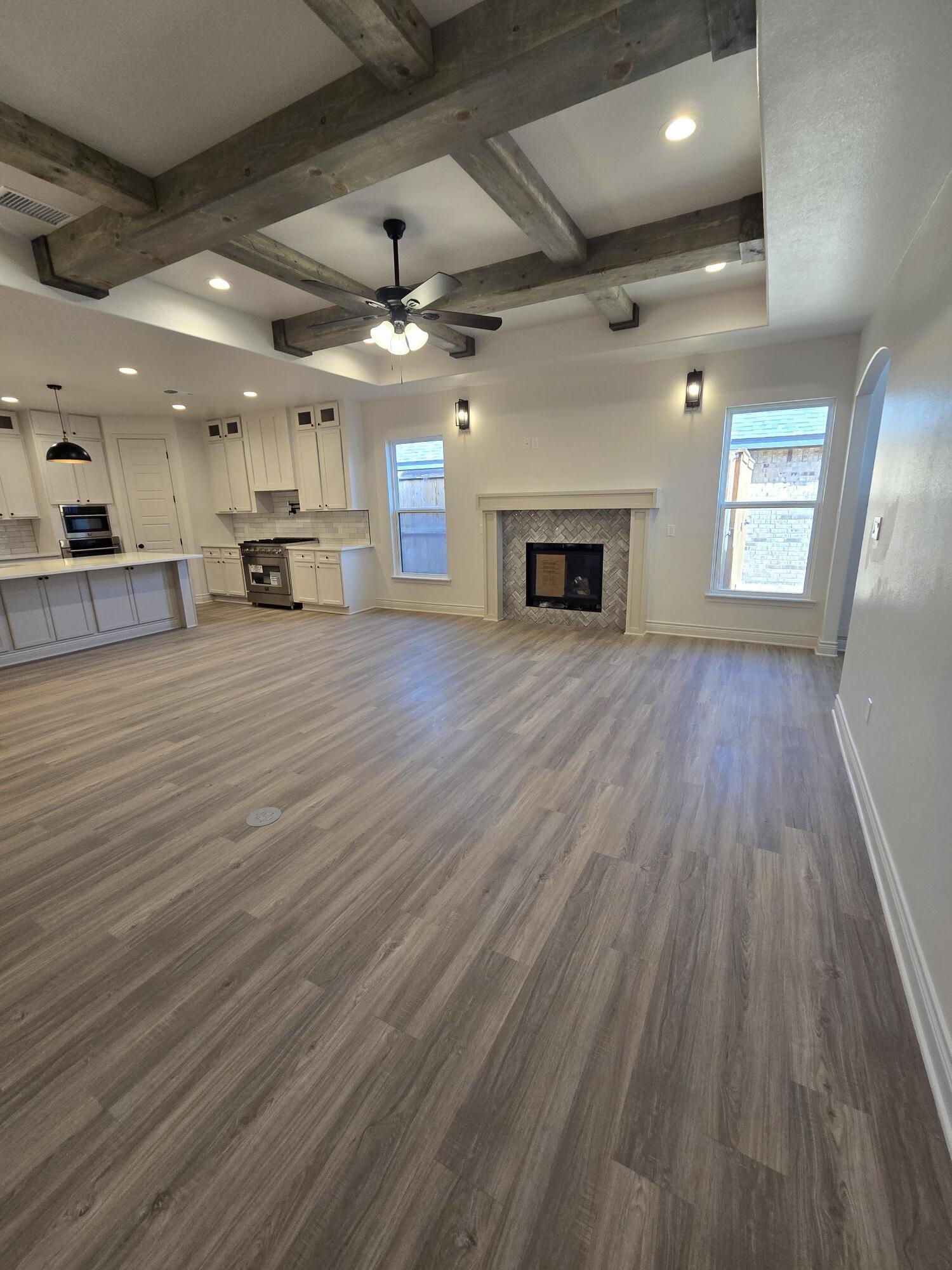 7814 53rd Street Lubbock, TX 79407 - Photo 5 of 24 a view of a room with wooden floor fireplace and window