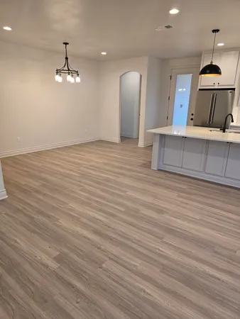 a view of a room with wooden floor