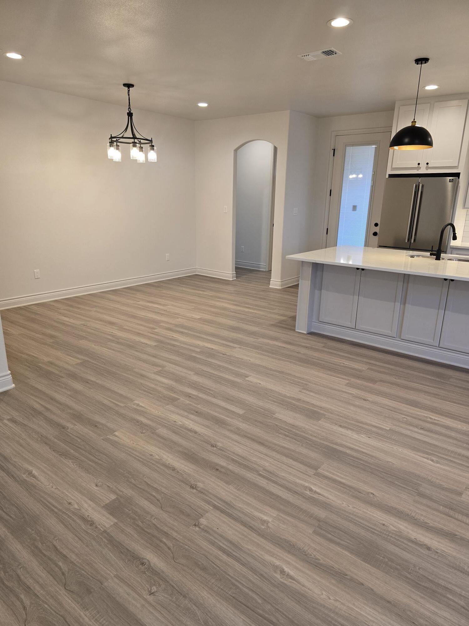 7814 53rd Street Lubbock, TX 79407 - Photo 7 of 24 a view of a room with wooden floor