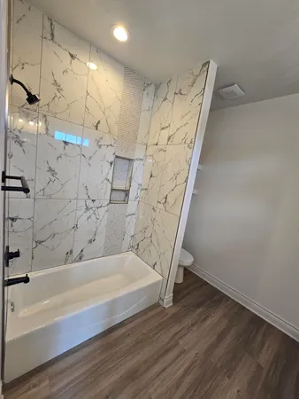 a bathroom with a bathtub and shower