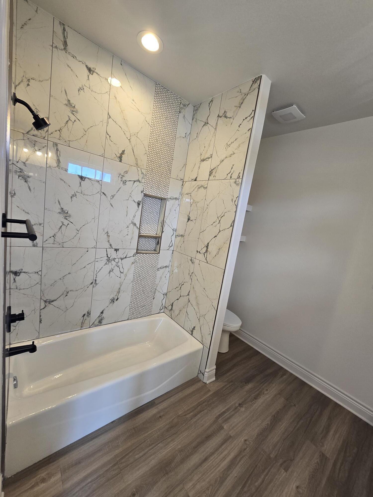 7814 53rd Street Lubbock, TX 79407 - Photo 8 of 24 a bathroom with a bathtub and shower