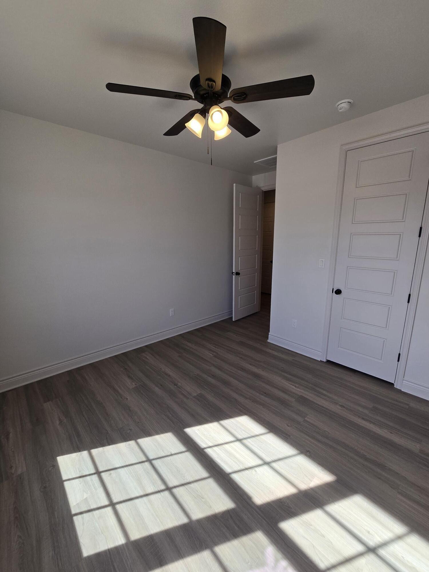 7814 53rd Street Lubbock, TX 79407 - Photo 9 of 24 a view of an empty room and wooden floor