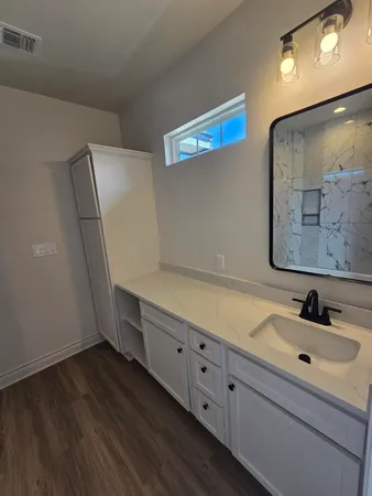 a bathroom with a sink and mirror