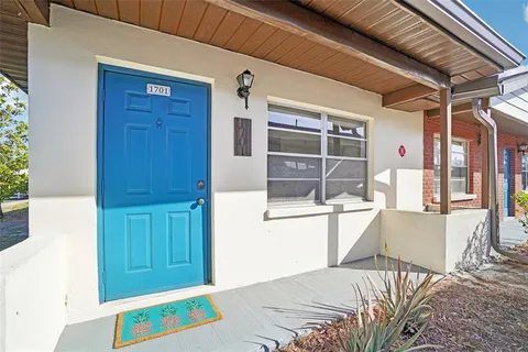 a view of a bedroom with a bed and a window