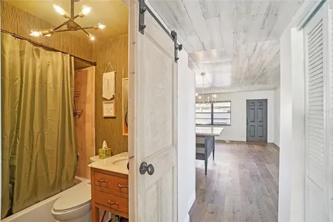 a bathroom with a shower toilet and sink