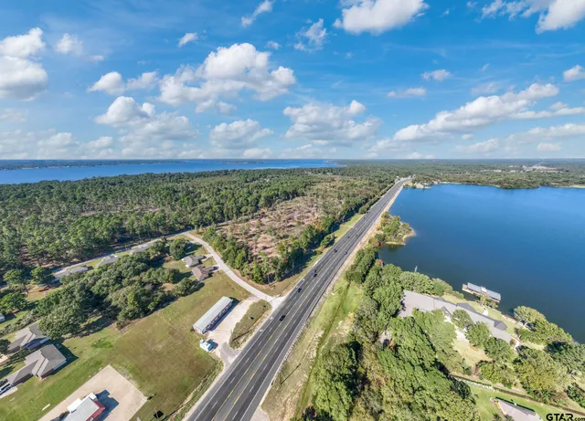 a view of a lake with houses in the back