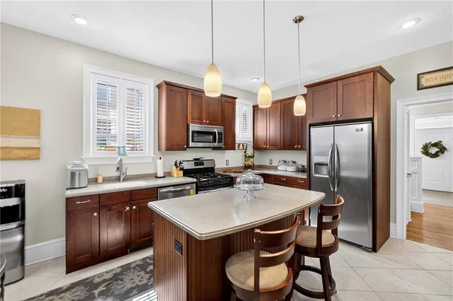 a kitchen with a table chairs refrigerator and microwave