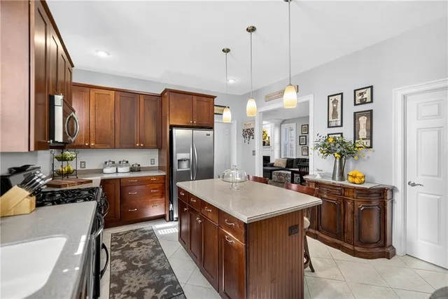 a kitchen with a refrigerator a sink and wooden cabinets