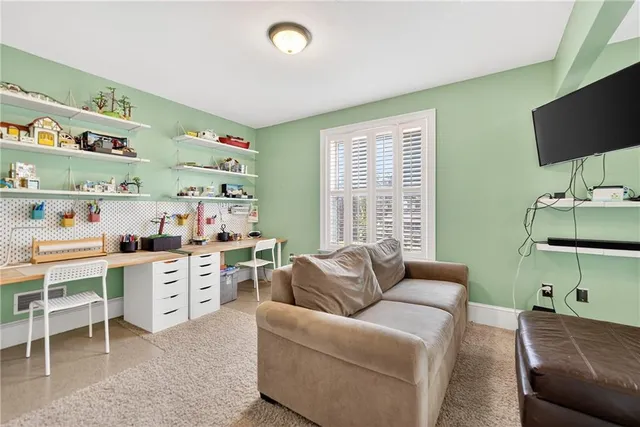 a living room with furniture window and flat screen tv