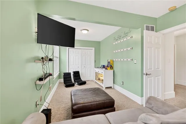a bedroom with a bed and a flat tv screen