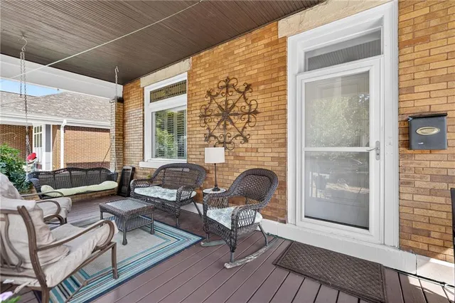 a living room with patio furniture and a fireplace