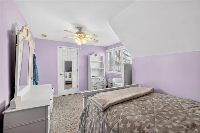 a bedroom with a bed dresser and a window