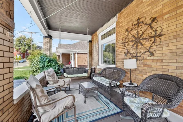 a view of a patio with couches table and chairs and potted plants