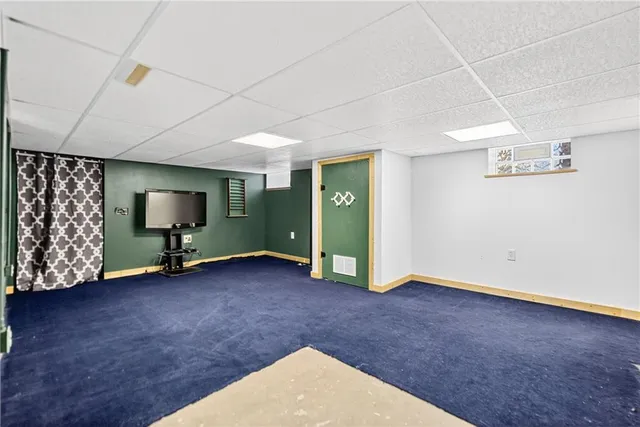 a view of a house with wooden deck and furniture