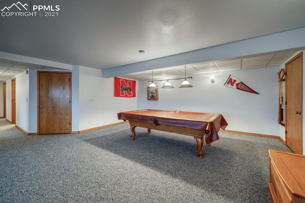 13770 Woodlake Road Elbert, CO 80106 - Photo 14 of 43 a room with stairs and a table