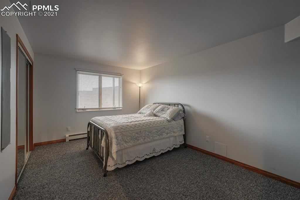 13770 Woodlake Road Elbert, CO 80106 - Photo 16 of 43 a bed sitting in a room next to a window
