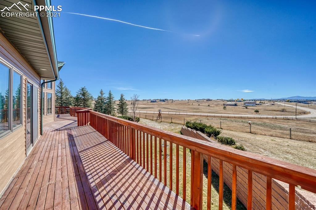 13770 Woodlake Road Elbert, CO 80106 - Photo 24 of 43 a view of balcony with couch and wooden floor